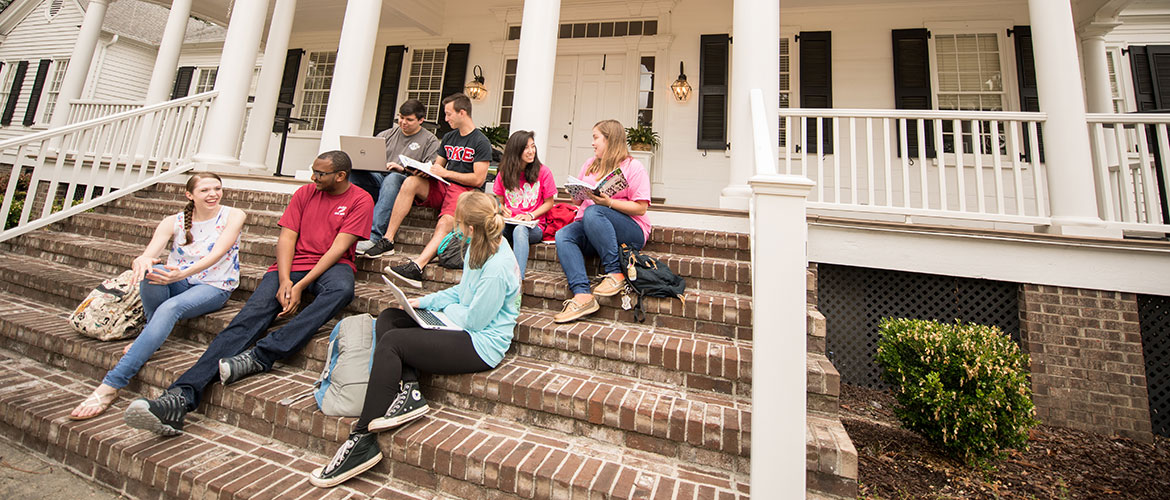 Students on the front steps of the Alumni House