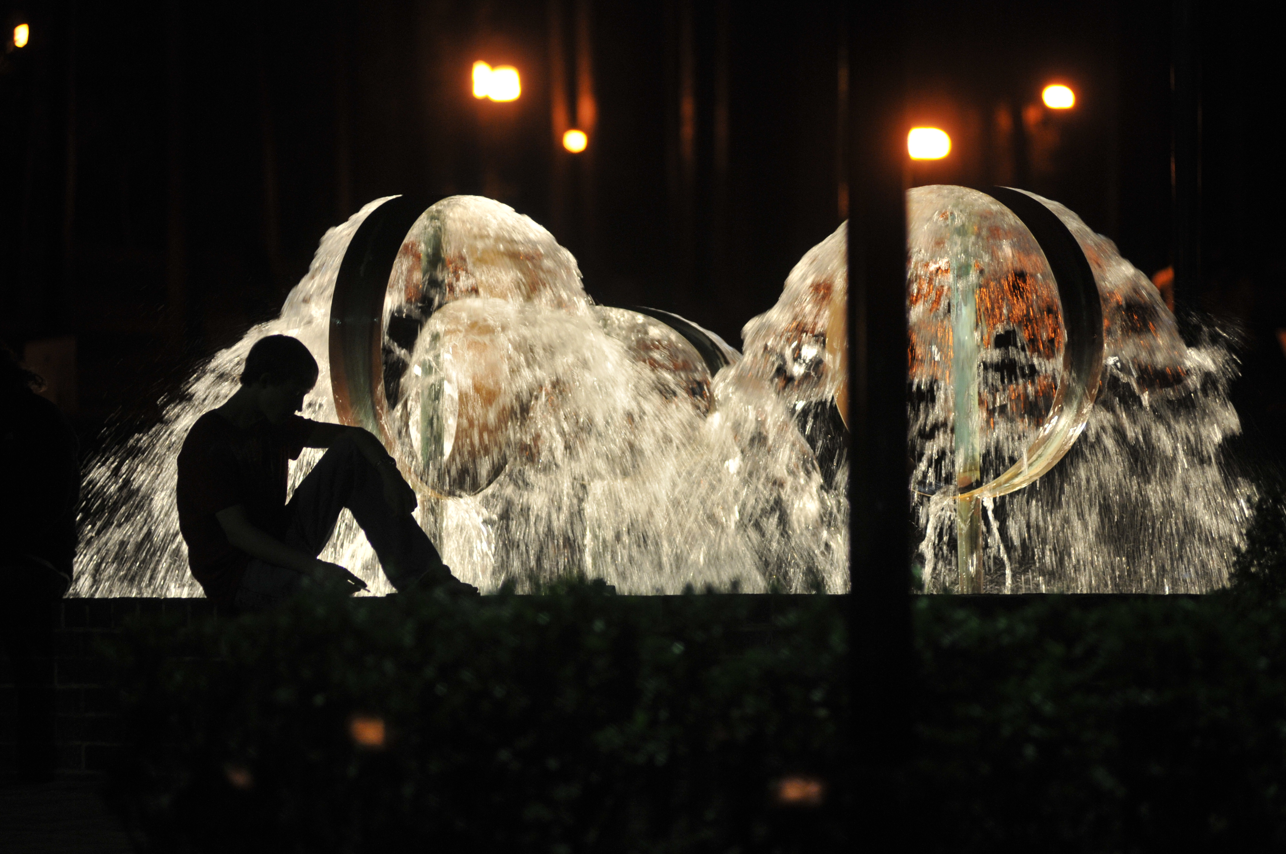 silhouette of student at the quad fountain