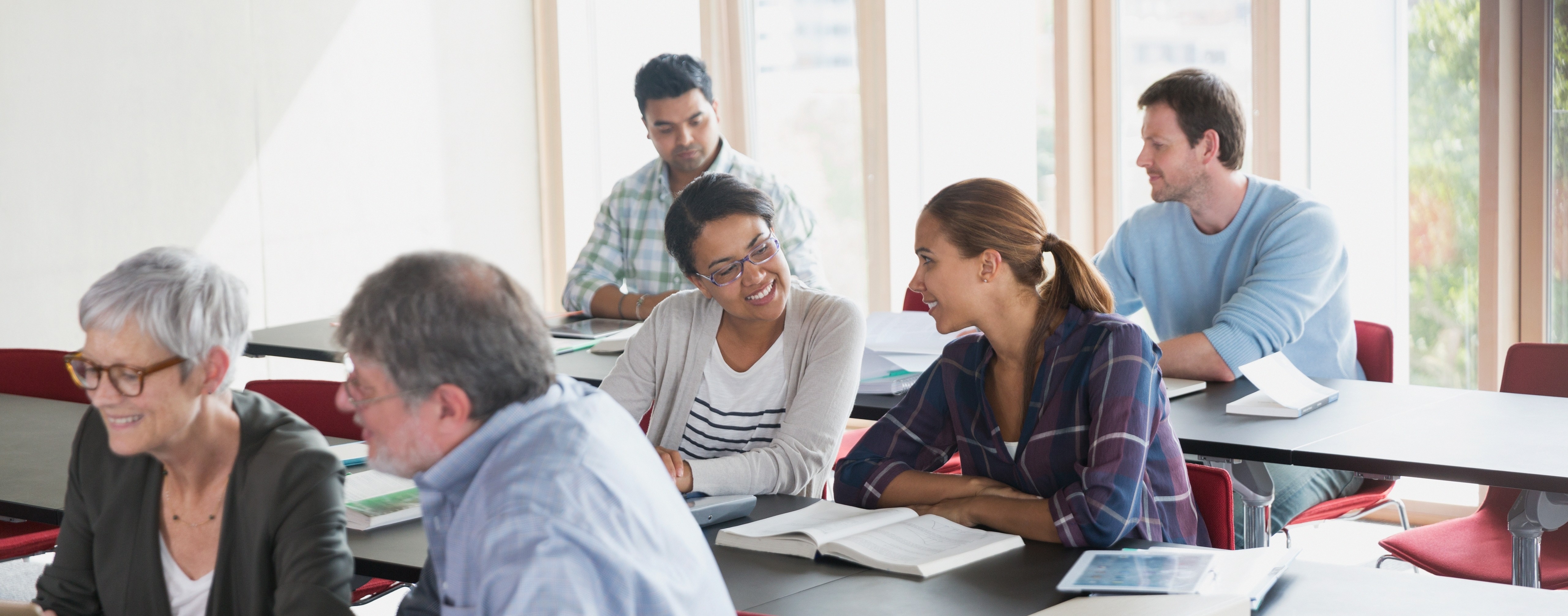 Photo of working professionals attending a professional development workshop.