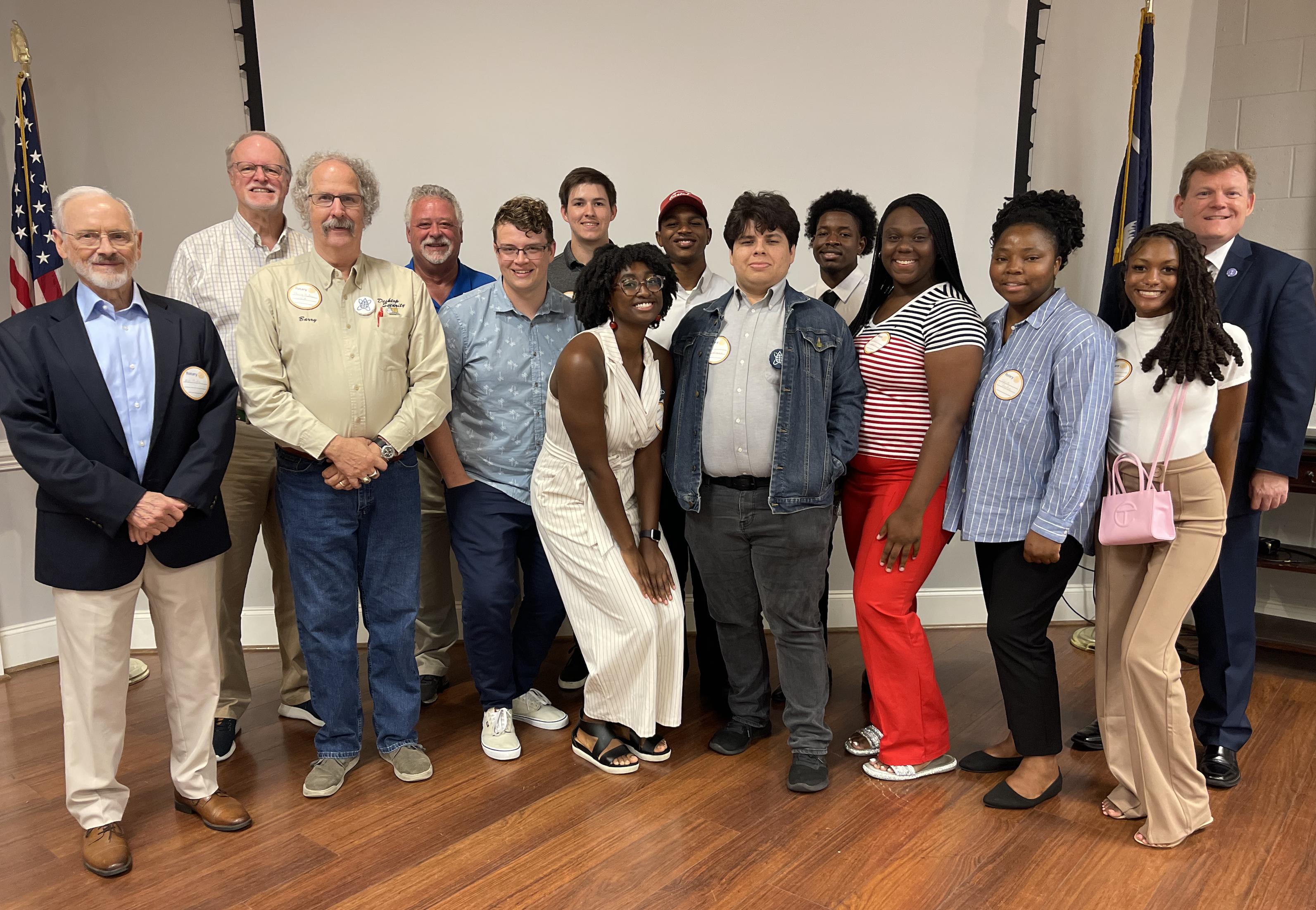 Barry Hudson, one of three of the cybersecurity professors advising the group, stands alongside the cybersecurity interns.
