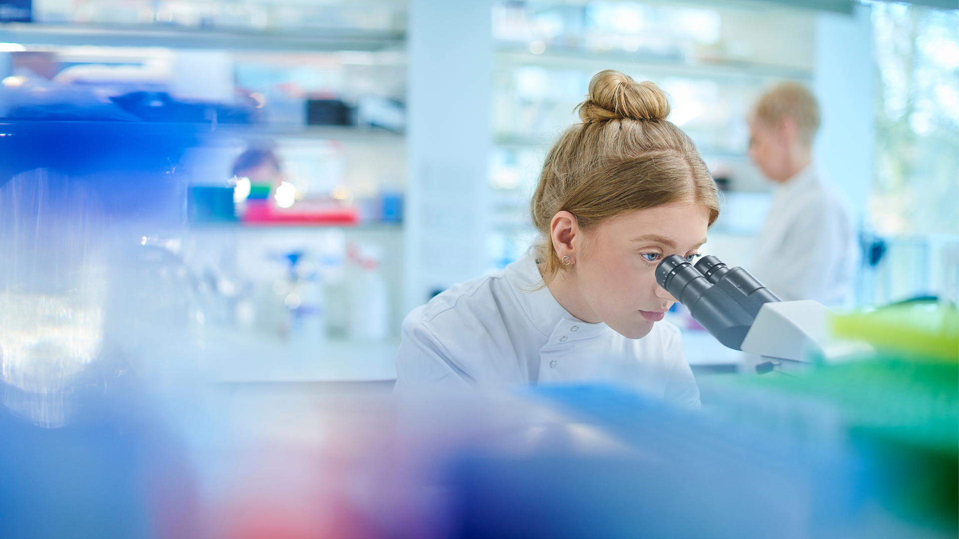 Student looking at microscope